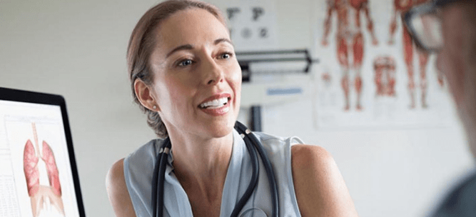 Doctor speaking with patient and smiling Doctor speaking with patient and smiling