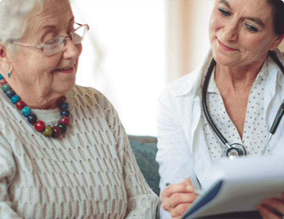 Doctor and elderly female patient reviewing results Doctor and elderly female patient reviewing results