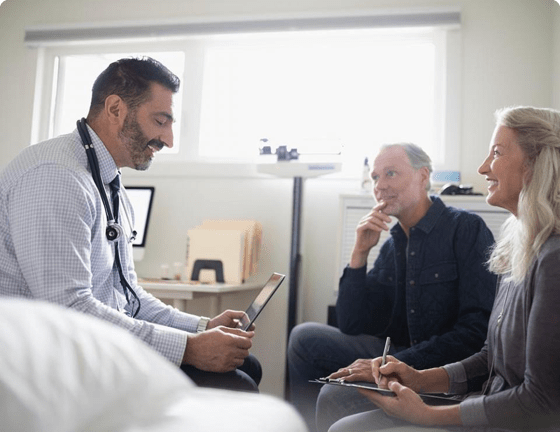 Doctor using iPad in front of patients Doctor using iPad in front of patients