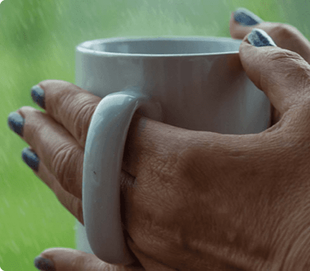 Hand holding a hot drink Hand holding a hot drink