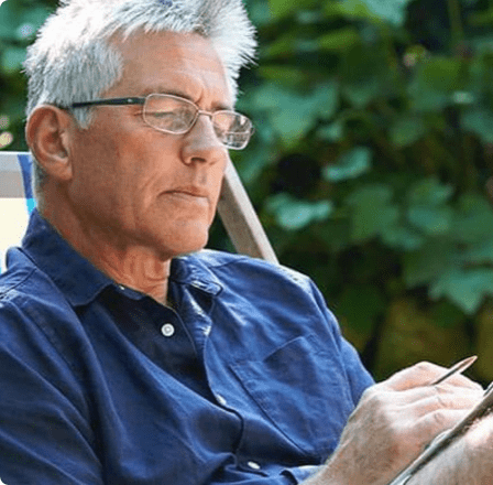 Middle aged man reading with glasses Middle aged man reading with glasses