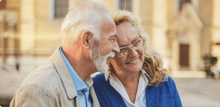 Older couple outside, smiling together Older couple outside, smiling together
