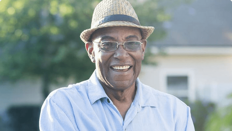 Smiling man standing in a garden Smiling man standing in a garden