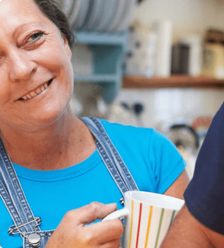 Woman smiling with cup in hand Woman smiling with cup in hand